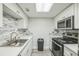 Contemporary kitchen with white cabinetry, stylish backsplash, and modern appliances at 936 Lake Destiny Rd # G, Altamonte Springs, FL 32714