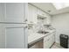 Modern kitchen features white cabinets, quartz countertops, and stainless steel appliances at 936 Lake Destiny Rd # G, Altamonte Springs, FL 32714