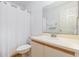 Neat bathroom featuring a vanity with a sink, toilet, and shower with white curtain at 2727 N Poinciana Blvd # 134, Kissimmee, FL 34746