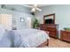 Relaxing bedroom with light blue walls, ceiling fan, and dark wood furniture at 2727 N Poinciana Blvd # 134, Kissimmee, FL 34746