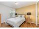 Comfortable bedroom with neutral tones, wood furniture, and ample natural light from the window at 2727 N Poinciana Blvd # 134, Kissimmee, FL 34746