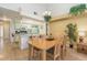 Cozy dining area featuring a light wood table set, open to the kitchen with modern appliances at 2727 N Poinciana Blvd # 134, Kissimmee, FL 34746