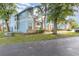 Charming two-story light blue condo with brick accents and beautiful landscaping at 2727 N Poinciana Blvd # 134, Kissimmee, FL 34746