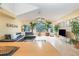 Bright living room with large windows, vaulted ceilings, leather sofa, and stylish decor at 2727 N Poinciana Blvd # 134, Kissimmee, FL 34746