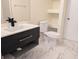 Bright bathroom with modern vanity, toilet, and stylish marble flooring at 1027 Sheeler Hills Dr, Apopka, FL 32703