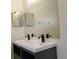 The bathroom features a double sink vanity, large mirror, and modern faucets at 1027 Sheeler Hills Dr, Apopka, FL 32703