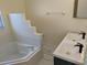 This bathroom showcases a modern double sink vanity, sleek faucets and a separate tub at 1027 Sheeler Hills Dr, Apopka, FL 32703