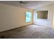 Spacious carpeted bedroom with natural light and large mirror at 1027 Sheeler Hills Dr, Apopka, FL 32703