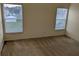 Bright bedroom with carpet, light walls and two large windows at 1027 Sheeler Hills Dr, Apopka, FL 32703