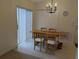 Bright dining area with wood table, chandelier, and sliding glass door provides great natural light at 1027 Sheeler Hills Dr, Apopka, FL 32703