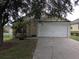 Charming single-story home with a two-car garage and a well-maintained front lawn at 1027 Sheeler Hills Dr, Apopka, FL 32703