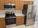 Modern kitchen featuring stainless steel appliances and wooden cabinetry at 1027 Sheeler Hills Dr, Apopka, FL 32703