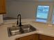 Stainless steel, double basin sink in the kitchen, with a window view at 1027 Sheeler Hills Dr, Apopka, FL 32703