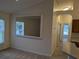 Cozy living room with large window and pass-through to the kitchen at 1027 Sheeler Hills Dr, Apopka, FL 32703