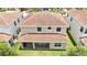 Aerial view of a home with a red tile roof and covered back patio at 10275 Henbury St, Orlando, FL 32832