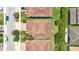 Aerial view shows well manicured lawn, red tile roof, and backyard hedges at 10275 Henbury St, Orlando, FL 32832