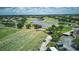 Aerial view of the golf course with water features, homes, and a practice area in a well-maintained community at 10275 Henbury St, Orlando, FL 32832