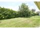View of the backyard with a well-kept lawn and privacy landscaping, ideal for outdoor enjoyment at 10275 Henbury St, Orlando, FL 32832