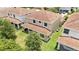 The backyard features a lush green lawn, red tile roof, and a covered patio perfect for outdoor living at 10275 Henbury St, Orlando, FL 32832
