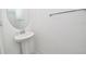 Elegant pedestal sink and oval mirror add charm to this powder room at 10275 Henbury St, Orlando, FL 32832