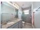 Modern bathroom with dual sinks, granite counters, and a large glass shower at 10275 Henbury St, Orlando, FL 32832