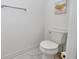 Toilet in the bathroom with white walls and marble floors at 10275 Henbury St, Orlando, FL 32832