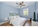 Comfortable bedroom with bright window, ceiling fan, and natural light at 10275 Henbury St, Orlando, FL 32832