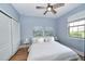 Comfortable bedroom with bright window, ceiling fan, and closet with doors at 10275 Henbury St, Orlando, FL 32832