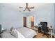 Bedroom with a gray comforter, ceiling fan, and a bathroom with a granite countertop in the background at 10275 Henbury St, Orlando, FL 32832