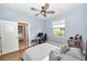 Bedroom with a gray comforter, ceiling fan, and a bathroom with a granite countertop in the background at 10275 Henbury St, Orlando, FL 32832