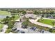 Aerial view of the clubhouse with parking lot and beautiful landscaping on the golf course at 10275 Henbury St, Orlando, FL 32832