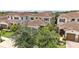 A two-story home with a red tile roof and a manicured lawn with a two-car garage at 10275 Henbury St, Orlando, FL 32832
