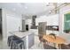 Modern kitchen with white cabinets, stainless steel appliances, and an island with seating, perfect for entertaining at 10275 Henbury St, Orlando, FL 32832