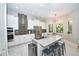 Modern kitchen with a large island, stainless steel appliances, white cabinets, and sleek countertops at 10275 Henbury St, Orlando, FL 32832