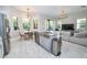 Open-concept kitchen and living area with stainless steel appliances and marble floors at 10275 Henbury St, Orlando, FL 32832