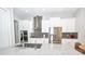 Bright kitchen with stainless steel appliances, white cabinets, granite counters, and a large island at 10275 Henbury St, Orlando, FL 32832