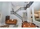 Bright living room with staircase, showcasing modern furnishings and an open layout, and neutral color palette at 10275 Henbury St, Orlando, FL 32832