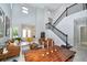 Open floor plan living room and dining area with staircase and neutral walls at 10275 Henbury St, Orlando, FL 32832