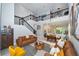 Bright and airy living room with high ceilings, modern decor, and staircase with black metal railings at 10275 Henbury St, Orlando, FL 32832