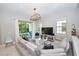 Comfortable living room with a large sectional sofa, stylish lighting, and access to the backyard patio at 10275 Henbury St, Orlando, FL 32832