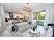 Spacious living room and kitchen featuring marble floors and sliding glass doors to outdoor patio at 10275 Henbury St, Orlando, FL 32832