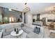 Bright and spacious living area seamlessly connected to a modern kitchen and dining space at 10275 Henbury St, Orlando, FL 32832