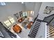 Open-concept living room with modern furnishings, a dining area, high ceilings, and staircase with decorative railing at 10275 Henbury St, Orlando, FL 32832