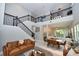 Spacious living room with staircase, featuring a modern design with high ceilings and an open floor plan at 10275 Henbury St, Orlando, FL 32832