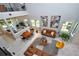 Open concept living room with high ceilings, modern decor, and abundant natural light from the many windows at 10275 Henbury St, Orlando, FL 32832