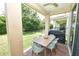 Covered patio features brick floor, ceiling fan, and outdoor dining set for comfortable outdoor living at 10275 Henbury St, Orlando, FL 32832