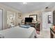Bedroom featuring a metal bed frame, blue blanket, ensuite bathroom, dresser and TV at 10359 Smyrna Dr, Orlando, FL 32817