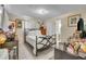 Cozy bedroom featuring a wrought iron bed frame, natural light, and ensuite bathroom at 10359 Smyrna Dr, Orlando, FL 32817