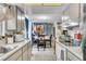 Bright kitchen with white cabinets and appliances, flowing into dining area with blue accent wall at 10359 Smyrna Dr, Orlando, FL 32817