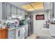 Well-lit kitchen with white appliances, tile floor, and ample counter space at 10359 Smyrna Dr, Orlando, FL 32817